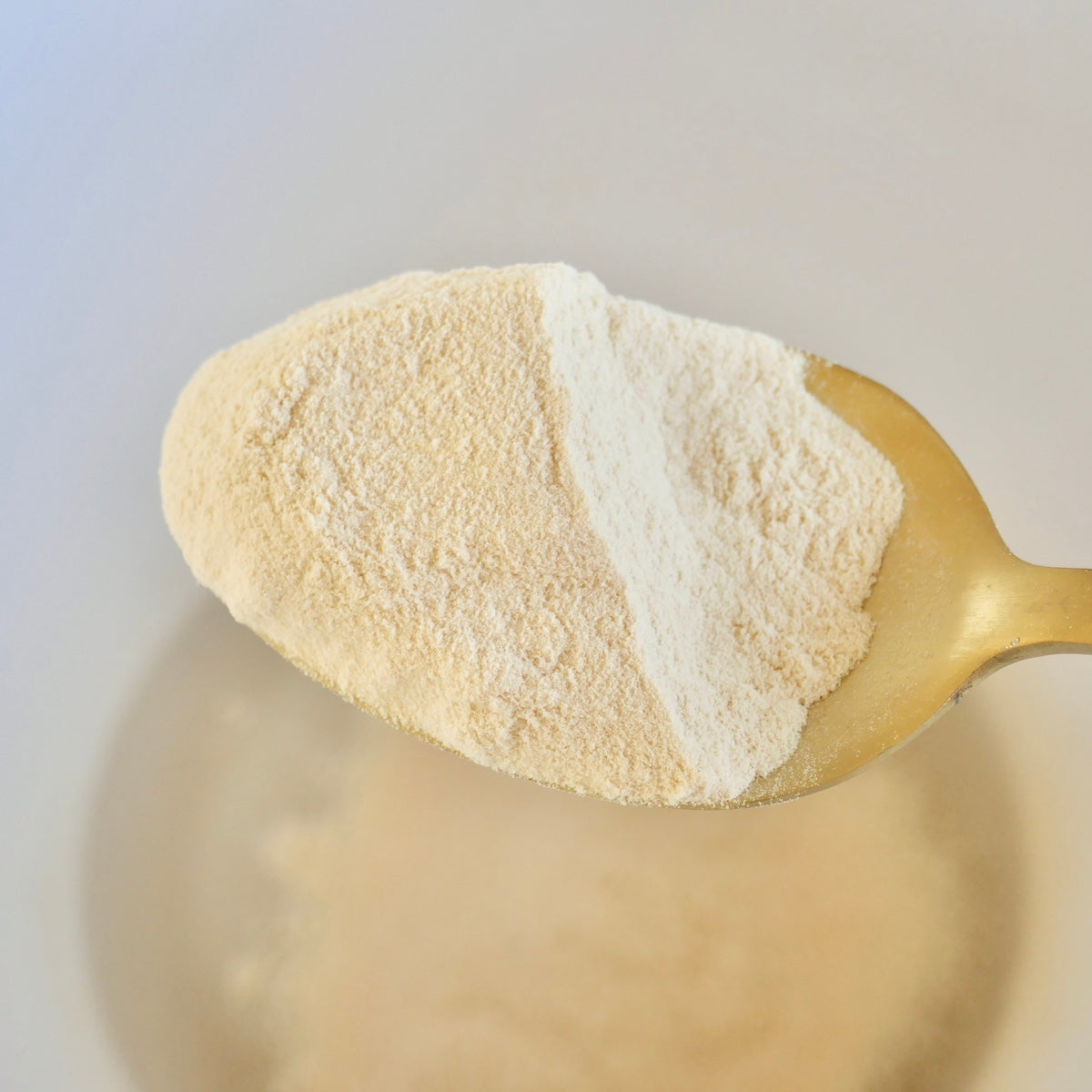 Scoop Of Raw Baobab Powder On Golden Spoon